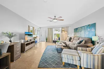 a living room with a couch and a tv at 2 bed, steps from Wilton Drive, BBQ, fire pit in Fort Lauderdale