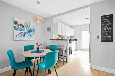 a kitchen and dining room with a table and chairs at 2 bed, steps from Wilton Drive, BBQ, fire pit in Fort Lauderdale