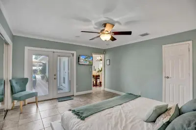 a bedroom with a bed and a ceiling fan at Waterfront, Heated Pool, Game Room in Fort Lauderdale