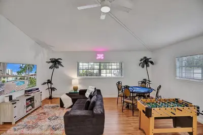 a living room with a couch and a table at Waterfront, Heated Pool, Game Room in Fort Lauderdale