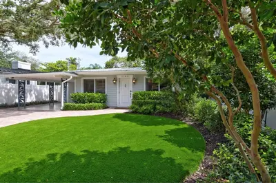 a house with a yard of green grass at Beach Oasis Heated Pool, Gazebo, Hot Tub in Fort Lauderdale
