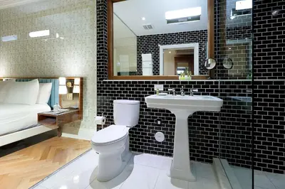 a bathroom with a white toilet and a sink at Eurostars Langford in Miami