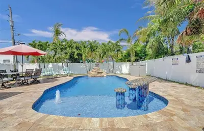 a swimming pool with a fountain in a yard at Aquaria in Fort Lauderdale