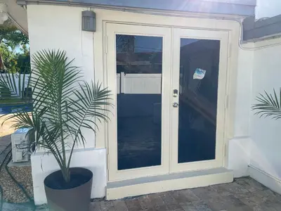 a door with a potted plant next to a house at Aquaria in Fort Lauderdale