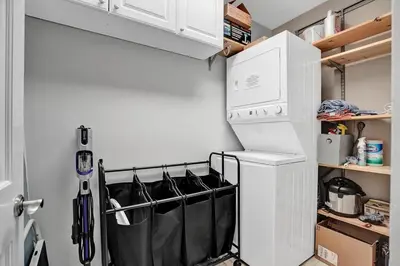 a kitchen with a washer and dryer next to a refrigerator at Fun Location! 1 block to Las Olas Pool & Parking in Fort Lauderdale
