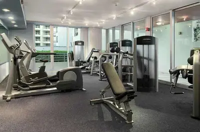 a gym with several treadms and machines in a building at Oceanfront Retreat- South Beach Pool Amenities in Miami Beach