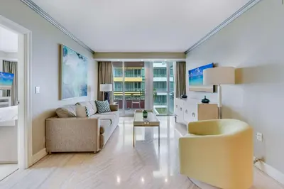 a living room with a couch and a table at Oceanfront Retreat- South Beach Pool Amenities in Miami Beach