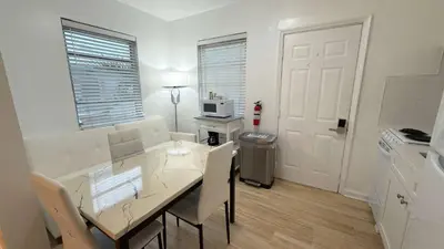 a kitchen and dining room with a table and chairs at Cozy 1BR Beach Apartment Walk to Miami Beach in Miami Beach
