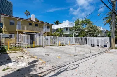 a white fence in front of a house at Cozy 1BR Beach Apartment Walk to Miami Beach in Miami Beach