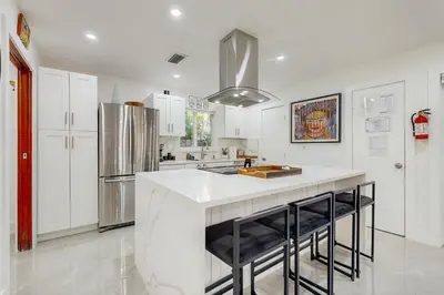 a kitchen with white cabinets and a white counter top at JS & JS 2040 LLC in Fort Lauderdale