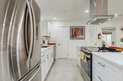 a large kitchen with a stainless steel refrigerator at JS & JS 2040 LLC in Fort Lauderdale