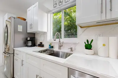 a white kitchen with a sink and a window at JS & JS 2040 LLC in Fort Lauderdale