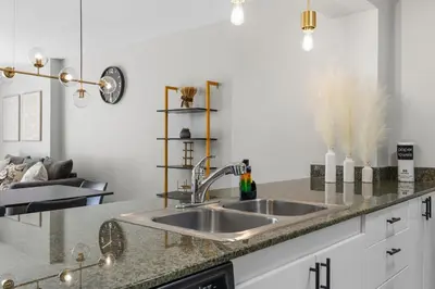 a kitchen with a sink and a counter top at Stylish Brickell Stay with Ocean Views & Pool in Miami