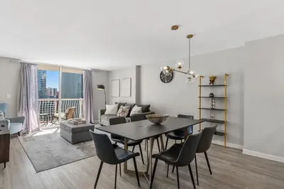 a living room with a table and chairs and a couch at Stylish Brickell Stay with Ocean Views & Pool in Miami