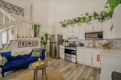 a living room with a blue couch in a kitchen at Suite Mar - Unit B in Miami