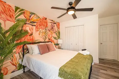 a bedroom with a bed with a tropical wallpaper at Suite Mar - Unit B in Miami