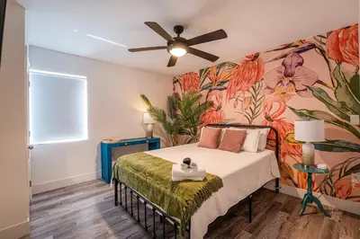 a bedroom with a bed with a flower mural at Suite Mar - Unit B in Miami