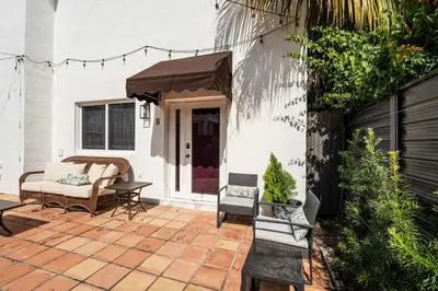 a patio with chairs and a table and a couch at Suite Mar - Unit B in Miami