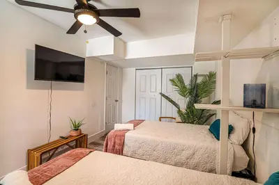 a bedroom with two beds and a ceiling fan at Suite Mar - Unit B in Miami