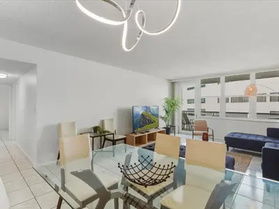 a dining room and living room with a glass table at Sea Air Towers - Oceanfront Condo w Pool & Gym in Hollywood
