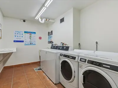 a laundry room with a washer and dryer at Sea Air Towers - Oceanfront Condo w Pool & Gym in Hollywood