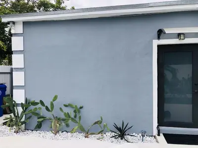 a blue garage with a door and a cactus at Buena Vista vacation home with privacy and close to everything in Miami