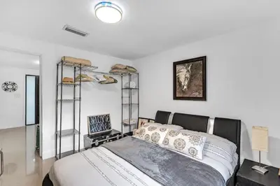 a bedroom with a bed and shelves in it at Buena Vista vacation home with privacy and close to everything in Miami