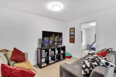 a living room with a couch and a book shelf at Buena Vista vacation home with privacy and close to everything in Miami