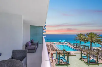 a view of a pool and the ocean from a hotel room at Lyfe Resort l Ocean Pool View Gym, Beach Access in Hollywood