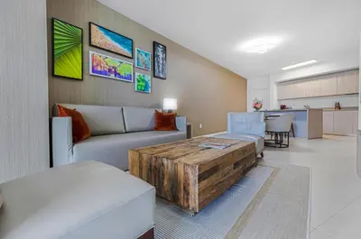 a living room with a couch and a table at Lyfe Resort l Ocean Pool View Gym, Beach Access in Hollywood