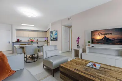 a living room with a table and a dining room at Lyfe Resort l Ocean Pool View Gym, Beach Access in Hollywood