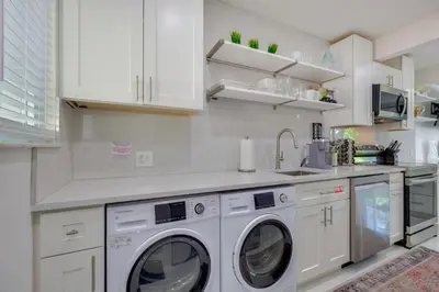 a kitchen with white cabinets and washing machines at Couples Retreat 1 Mi to Fort Lauderdale Riverwalk in Fort Lauderdale