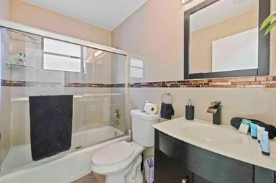a bathroom with a toilet and a sink and a shower at Serene Lakefront Getaway Fishing & Kayaks in Fort Lauderdale