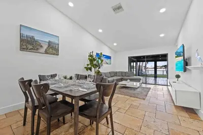 a dining room with a table and chairs at Serene Lakefront Getaway Fishing & Kayaks in Fort Lauderdale