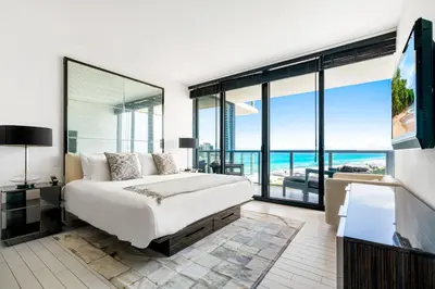 a bedroom with a bed and a view of the ocean at OceanView 1B Private Residence at South Beach - 1114 in Miami Beach