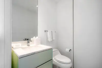 a white bathroom with a sink and a toilet at OceanView 1B Private Residence at South Beach - 1114 in Miami Beach