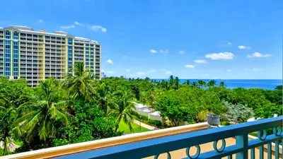 a view of the ocean from the balcony of a resort at Modern Miami Suite Near the Beach in Miami