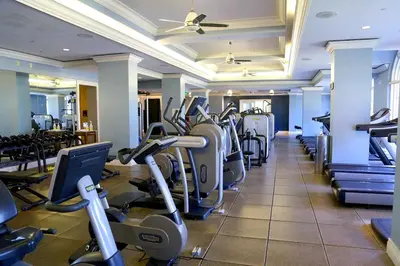 a gym with rows of cardio equipment in a hotel at Modern Miami Suite Near the Beach in Miami