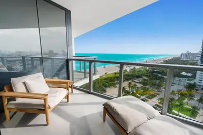 a bedroom with a view of the beach and the ocean at OceanView 1B Private Residence at South Beach -1614 in Miami Beach