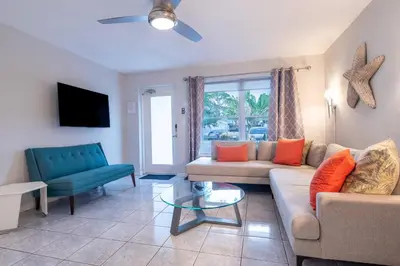 a living room with a couch and a chair at Wilton Manors Twin Oasis | 2 Heated Pools, For 12 in Fort Lauderdale