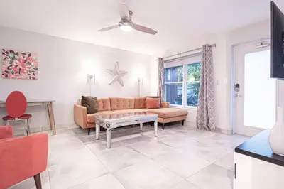 a living room with a couch and a table at Wilton Manors 2BR Bungalow, Private Pool, Sleeps 6 in Fort Lauderdale
