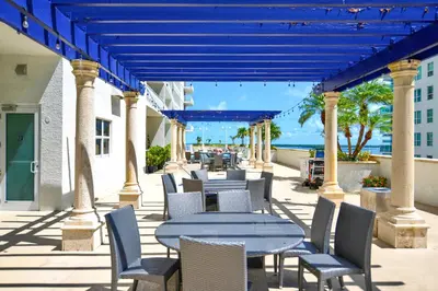 a patio with tables and chairs and the ocean at Modern Waterfront Apartment with Brickell City Views in Miami