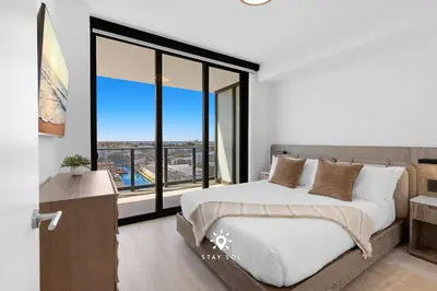 a bedroom with a bed and a large window at Chic 2BR Apartment Gym & Balcony Views in Miami Beach