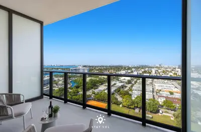 an apartment with a view of the ocean at Coastal Apartment - Pool & Breezy Balcony in Miami Beach