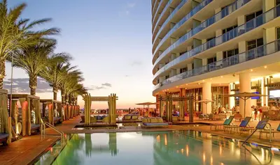 a hotel with a swimming pool next to a building at Lyfe Resort & Residences in Hollywood
