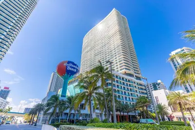 a tall building with palm trees in front of it at Ocean Luxe Pad for 6 Guests with Poolside Access in Hollywood
