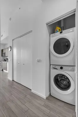 a washer and dryer in a white room at Downtown Luxe Studio Miami Skyline Retreat in Miami