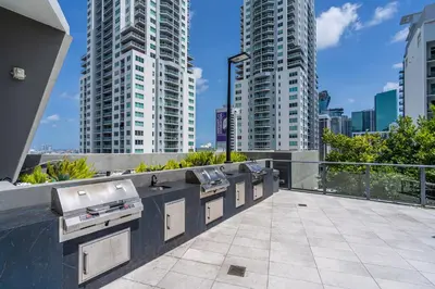 a row of sinks on a balcony with tall buildings at Downtown Luxe Studio Miami Skyline Retreat in Miami