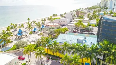 an aerial view of a city with palm trees and the ocean at Exclusive studio steps to the beach with pool in Hollywood