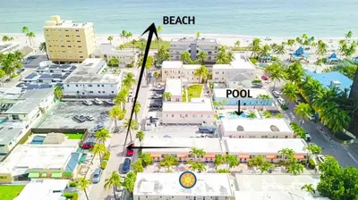 an aerial view of the beach and pool at a resort at Exclusive studio steps to the beach with pool in Hollywood